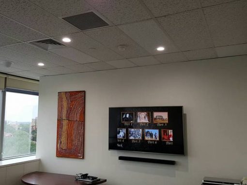 Hisense TV Wall Mounted in Office With Soundbar