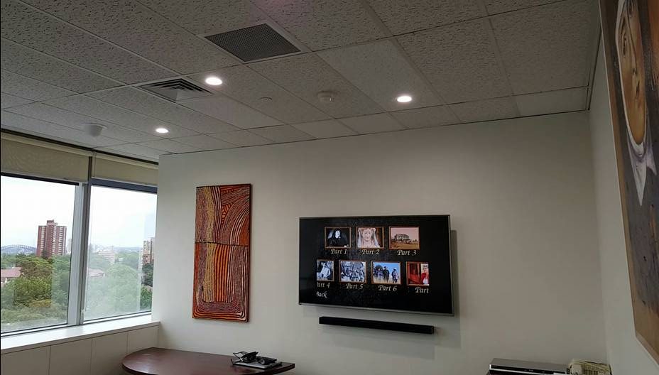 Hisense TV Wall Mounted in Office With Soundbar