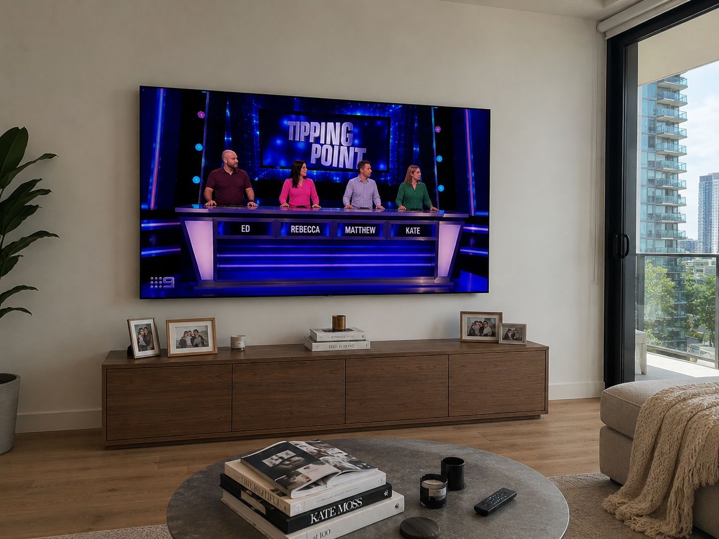 Large LG TV wall mounted above a timber cabinet in a modern Sydney apartment living room