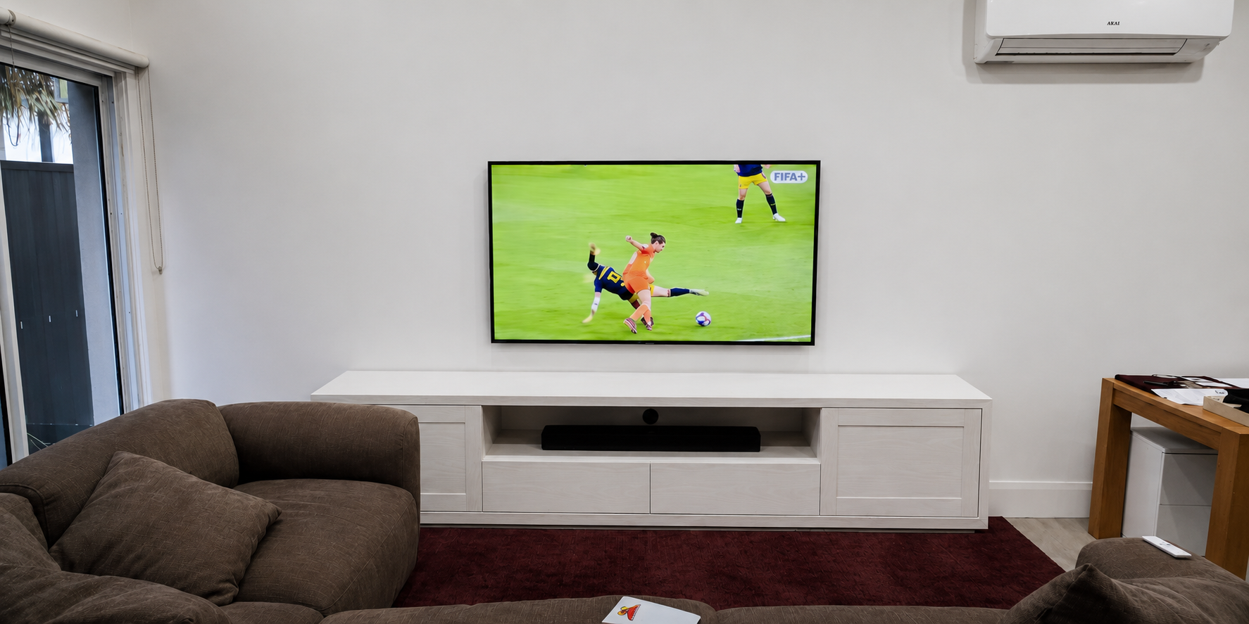 65 inch Samsung Frame TV LS03HE 4K wall mounted on a gyprock wall in a Sydney living room