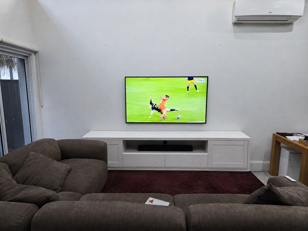 65 inch Samsung Frame TV LS03HE 4K wall mounted on a gyprock wall in a Sydney living room